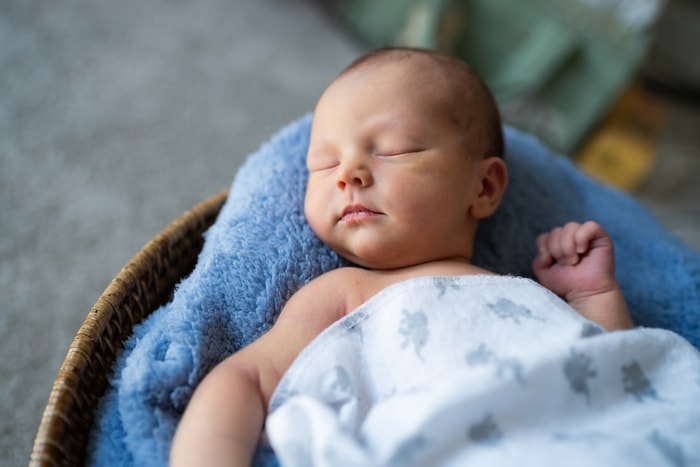 Newborn baby in a professional studio setup at home.