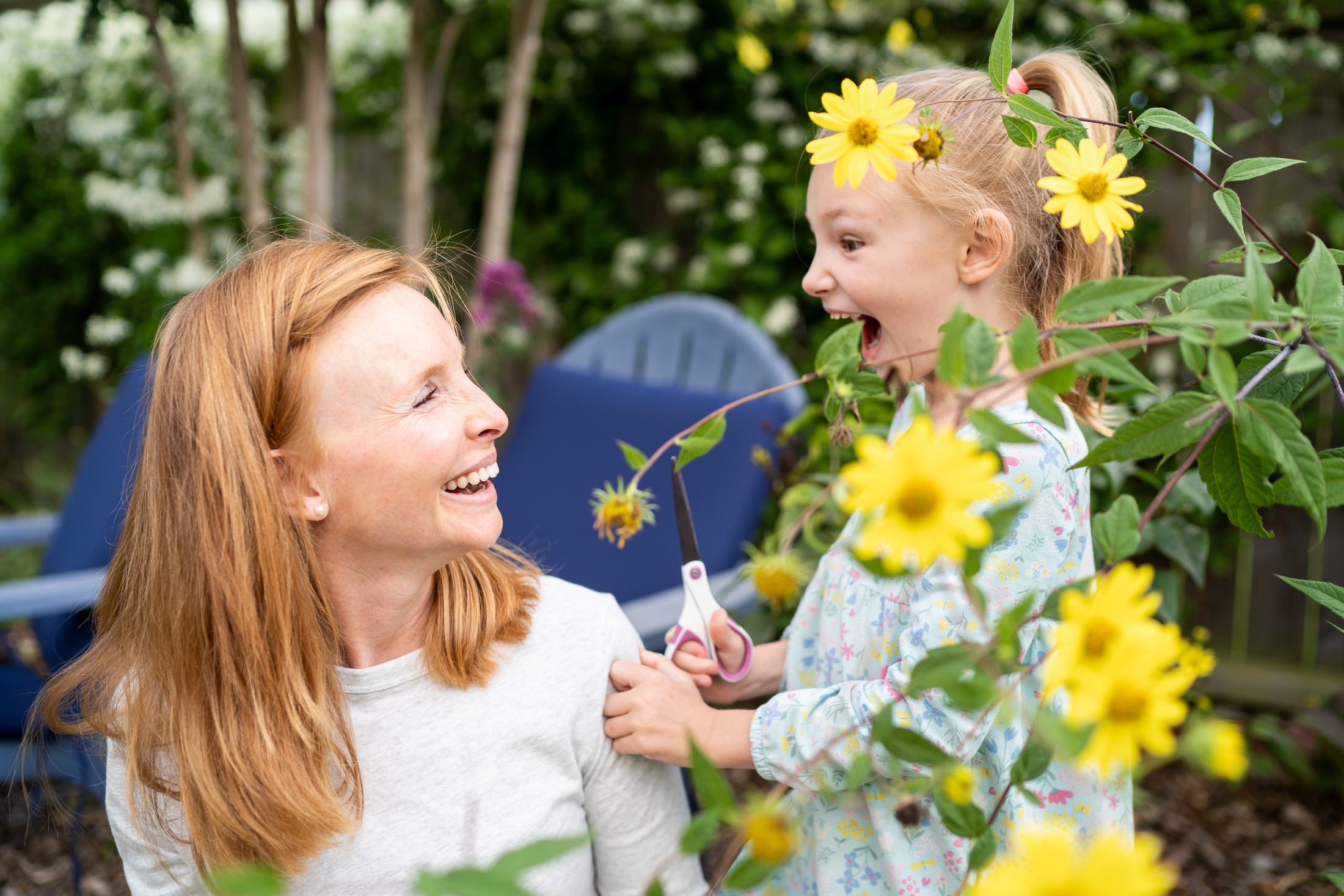 Flower power: Jancey's little girl adorning her parents with backyard blooms, the epitome of family fun.